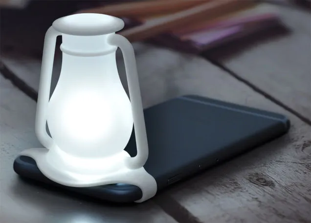 Travelamp is attached to your phone via a silicone strap, which keeps it in place over the camera's flash