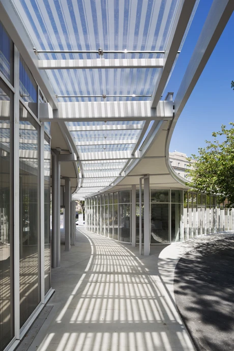 The new structure features a large glass building that has been embedded into an existing hill