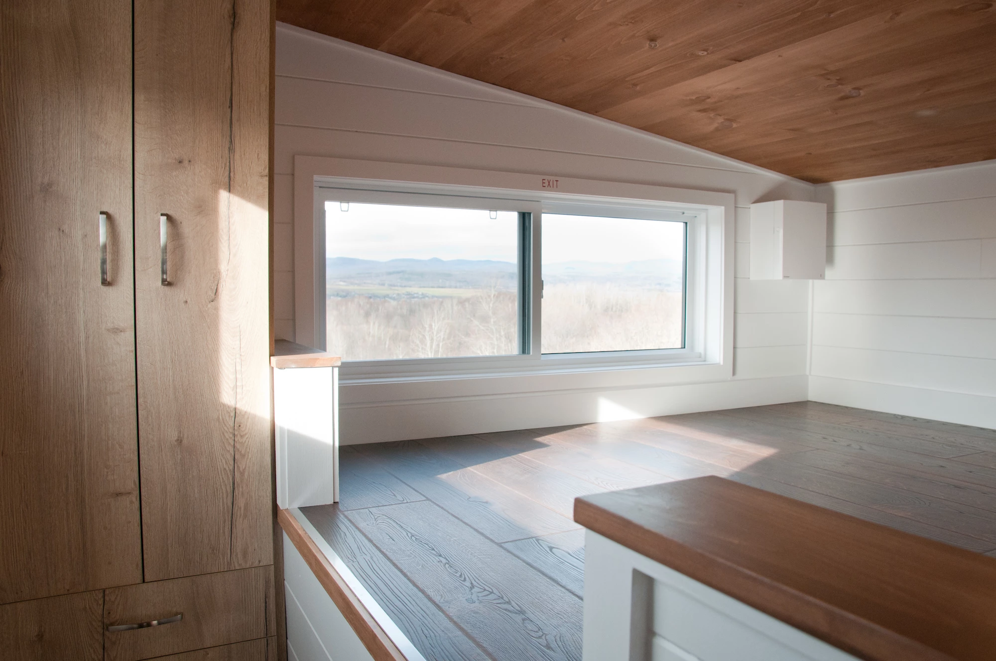 Other than its lowered platform area, the Charme V2's main loft bedroom is a typical tiny house-style bedroom with a low ceiling and space for a double bed