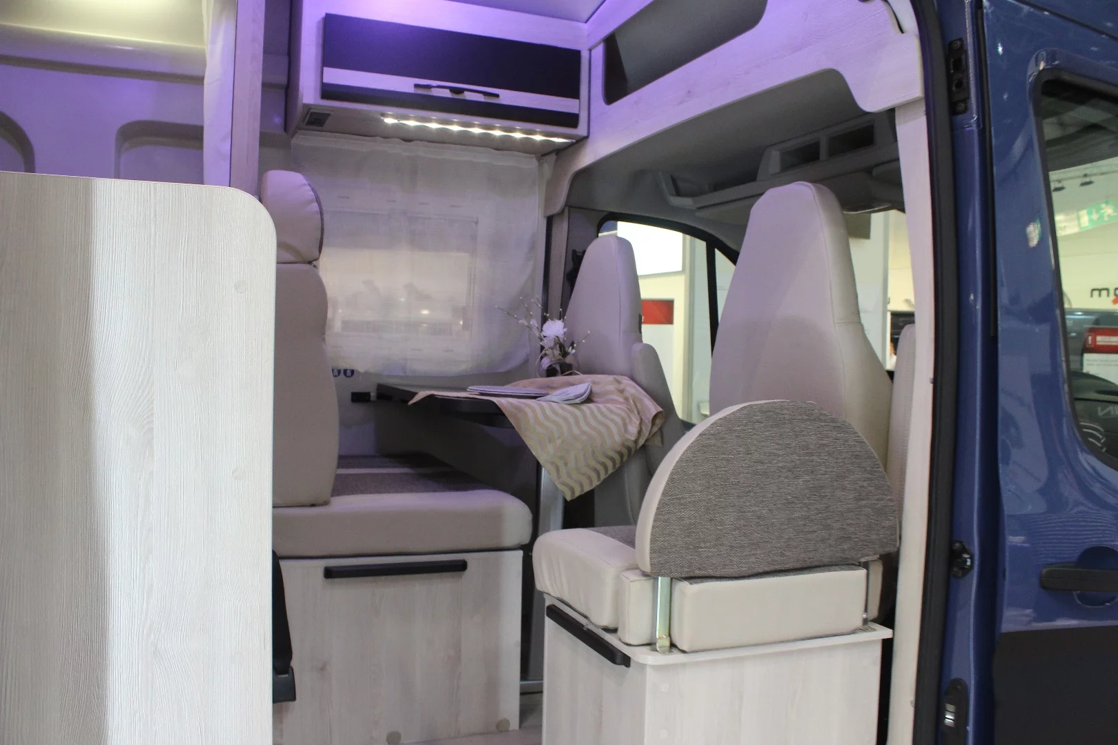 The seat inside the doorway serves as a fifth seat at camp and a support for the single bed