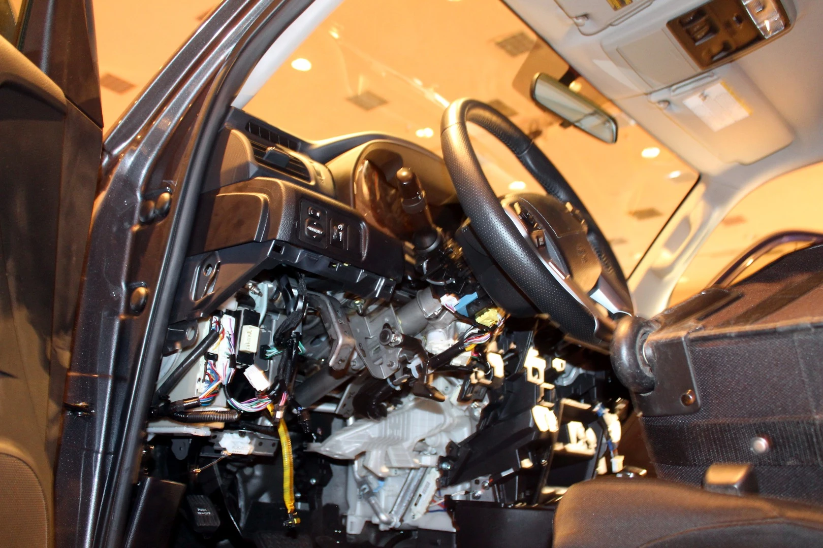 Vehicles with internal panels ripped out let DEF CON attendees see a car as a hacker might, as a plethora of possible cables, chips, and panels to explore