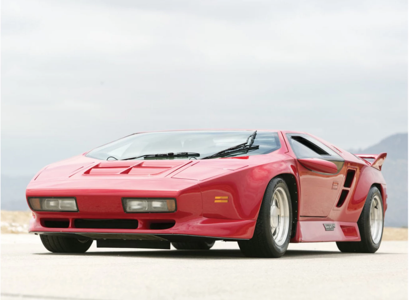 The Vector W8 was an American supercar produced from 1990 to 1993 utilizing aerospace materials. Just 19 W8s were produced and sold new for $448,000, an astonishing amount for the time. The cars featured an epoxy-bonded and riveted aluminum semi-monocoque chassis with an aluminum honeycomb floor pan, and the Rodeck Aluminum 365 cu. in. racing engine used twin intercooled turbochargers to produce 625 hp. The turbo boost levels were driver adjustable between 8 and 14 psi and the W8 had a claimed top speed of 242 mph (389 km/h).