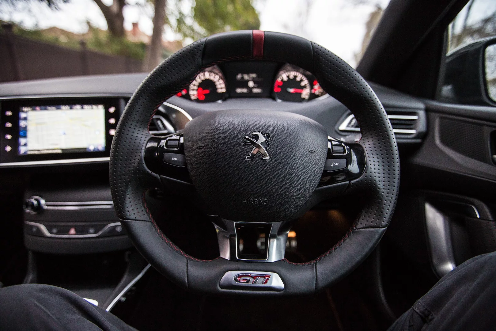 The chubby little steering wheel works well in the 308 GTi