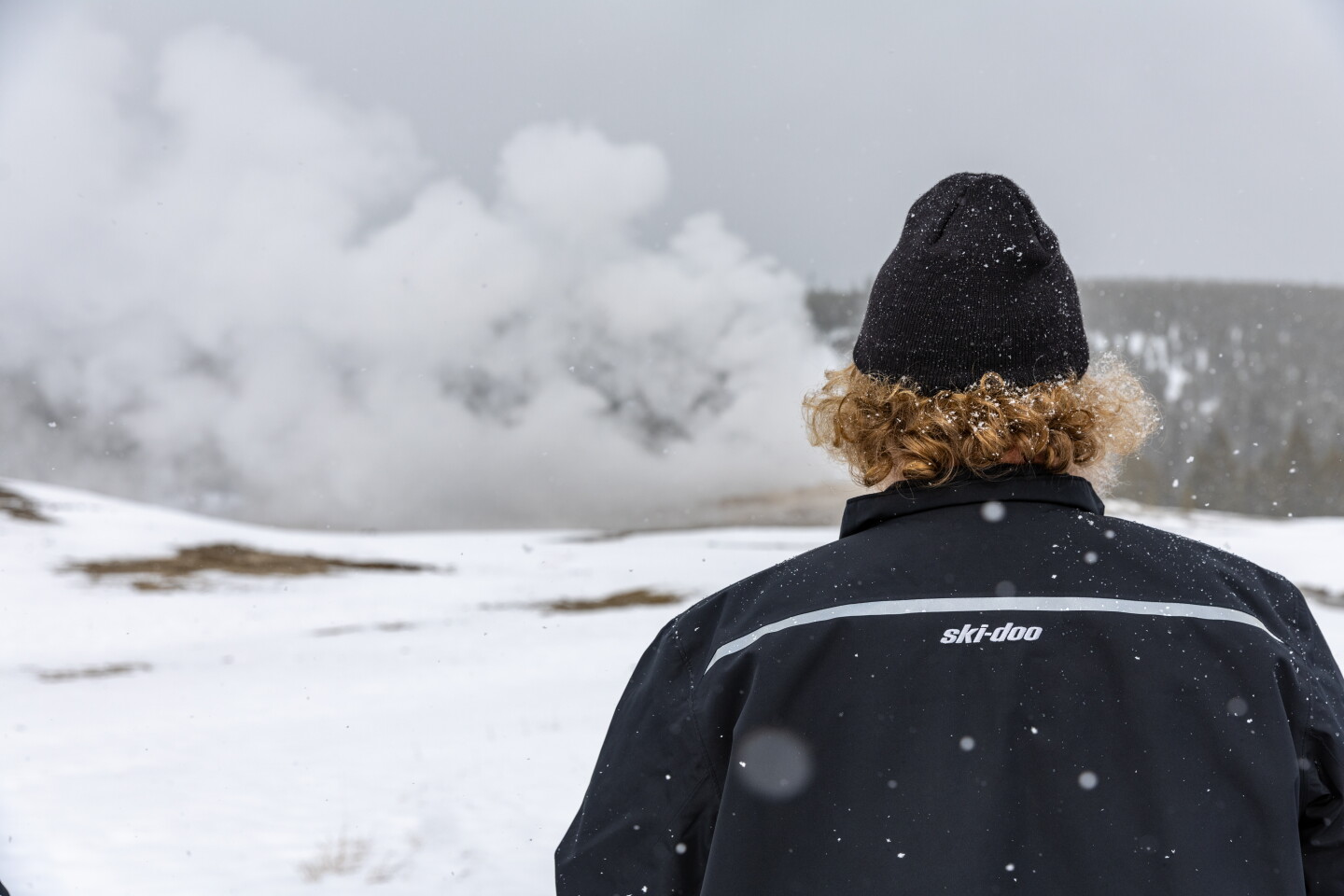 The author watches Old Faithful as it begins to erupt
