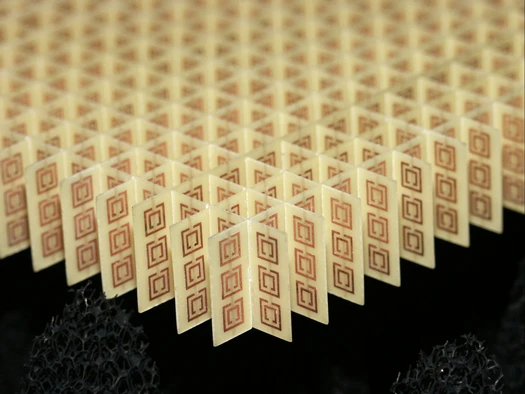 Left-handed metamaterial flat lens consisting of an array of 3 by 20 by 20 unit cells. With a unit cell width of 5 mm, this geometry shows reversed refraction and left-handed focusing properties at microwave frequencies between 10 and 11 GHz. (Image: NASA)