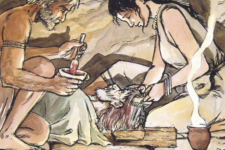 A drawing of a ritual inside a cave featuring a man and a woman seated on the ground and working