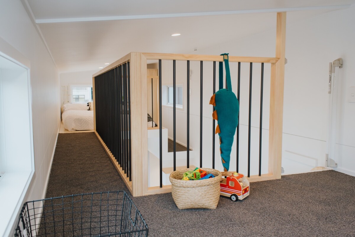 The Dance Tiny House's two lofts are joined by a catwalk with a safety barrier