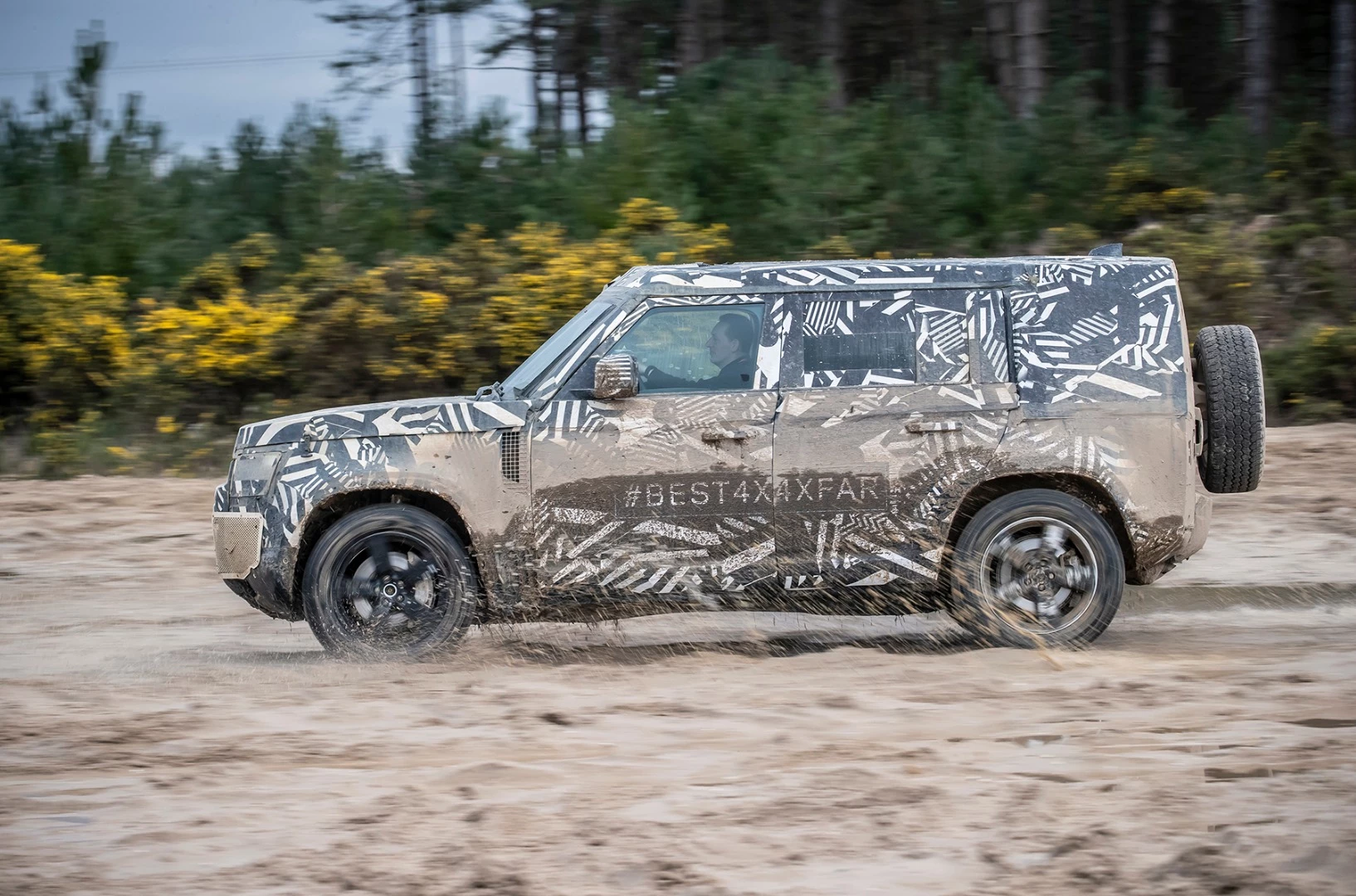 The prototype Land Rover Defender battling the mud of Eastnor, UK