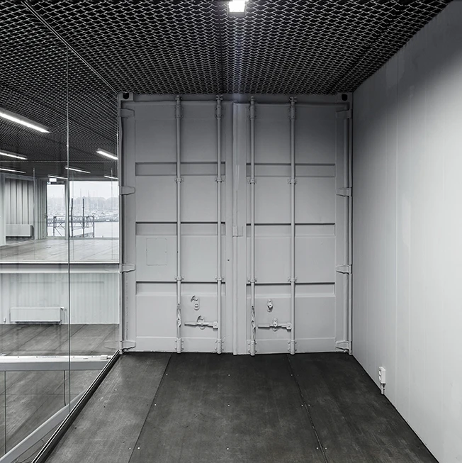 Made to be Moved features used shipping containers – complete with dents – that have been painted grey to produce a uniform look