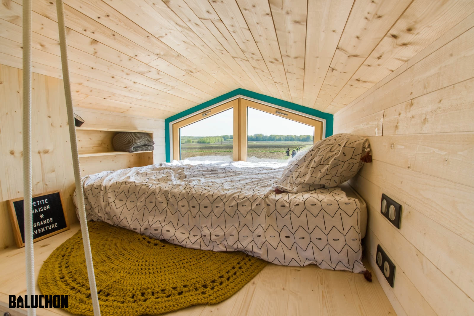 Tiny House Sïana's main bedroom includes a double bed and some storage space