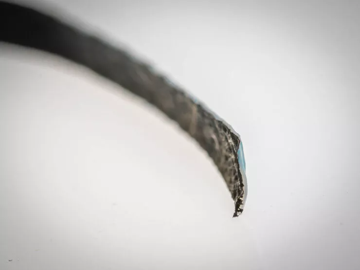 A strip of the material, with the black PPy visible on one side