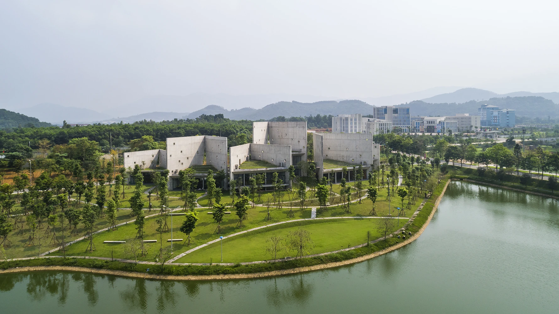 The Viettel Offsite Studio is located on the outskirts of Vietnam's capital Hanoi and is situated on a sloping plot of land, near a lake and trees