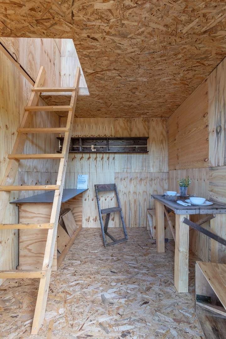 Project vertical cabin's interior is very simple and has some basic furniture attached to the walls