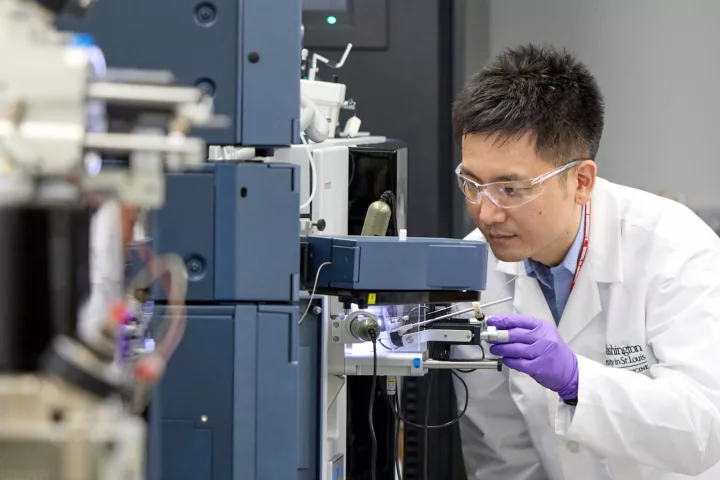 Researcher Kanta Horie from Washington University analyzes a blood sample using a mass spectrometer that measures protein levels