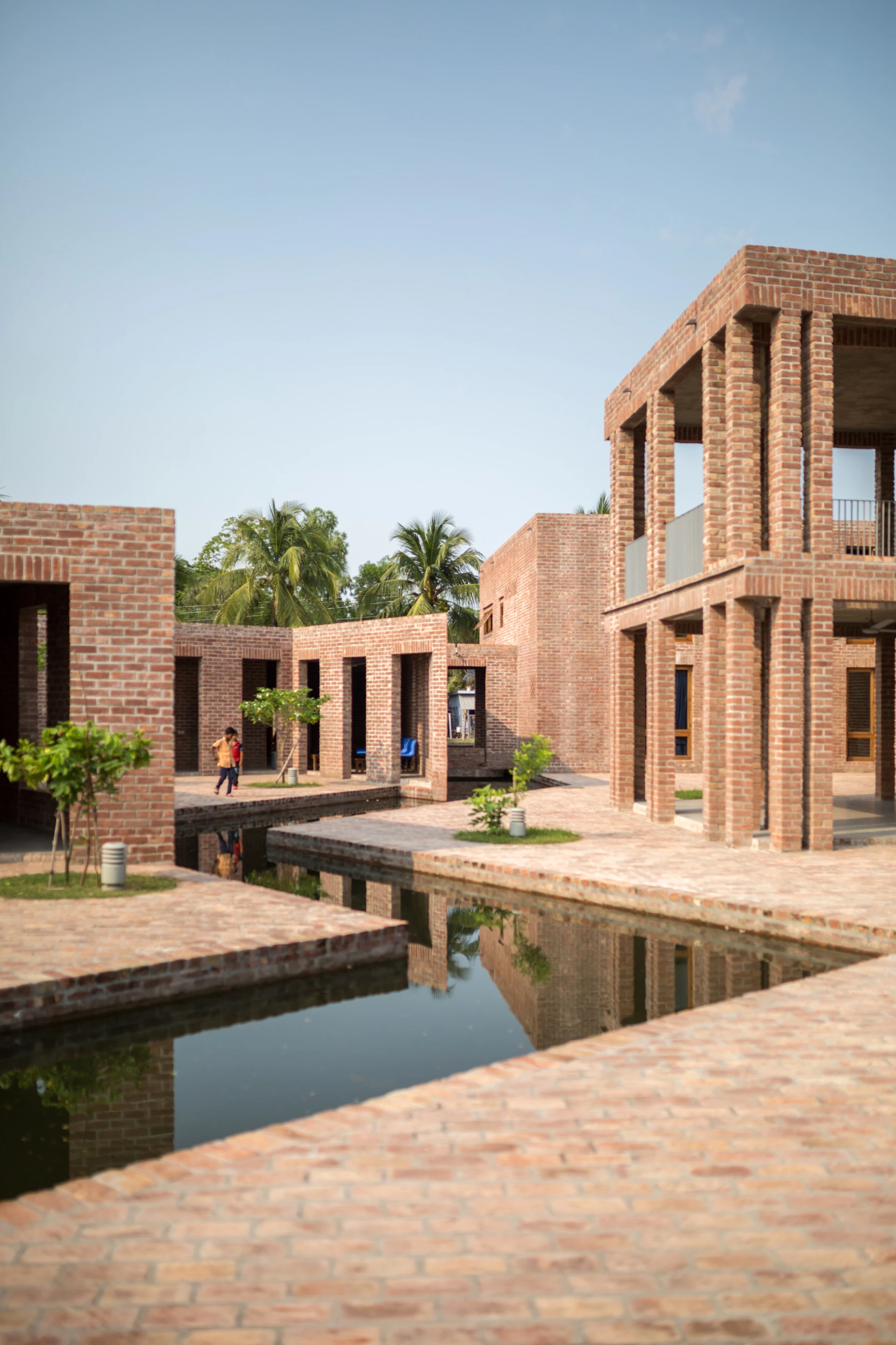 Friendship Hospital, Satkhira was designed by Kashef Chowdhury/URBANA and is located in Bangladesh. The hospital is designed to blend naturally into its rural surroundings and features a canal that collects rainwater