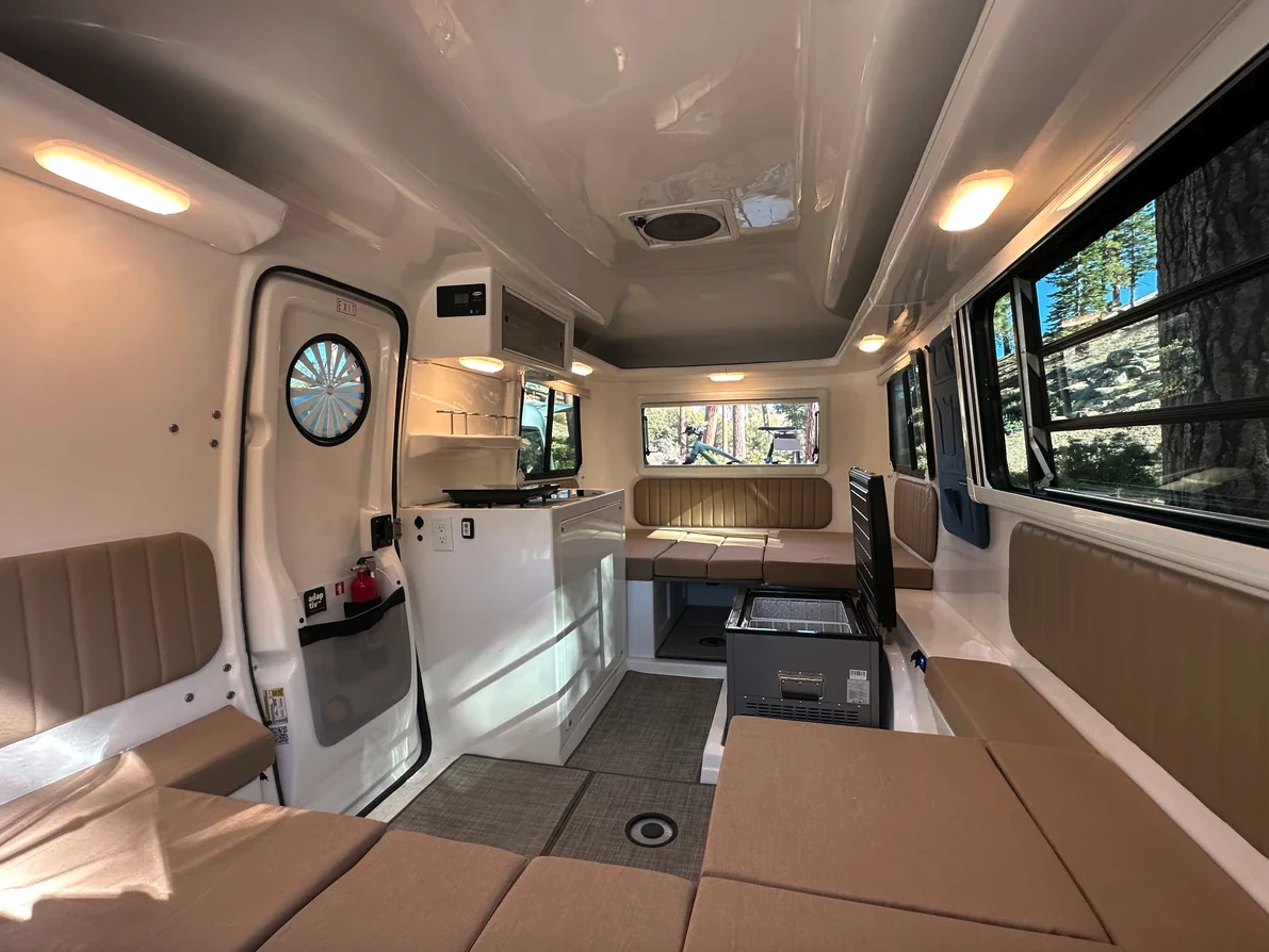 The more open layout of the base-level Traveler Essentials shows the space payoff of adding the bathroom, fridge console and cabinet