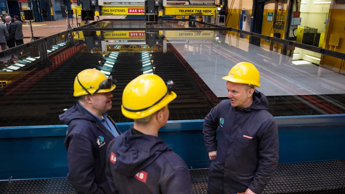 Workmen awaiting the first steel for the OPV being cut