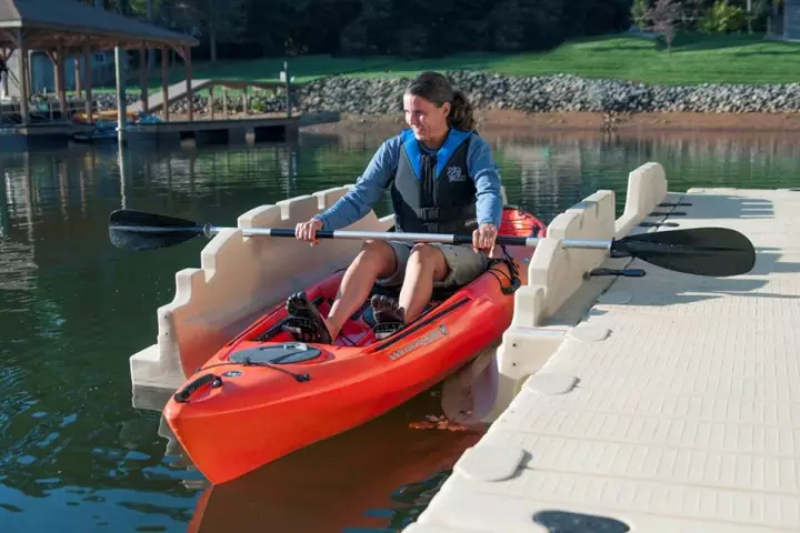 A kayaker uses the EZ Personal Launch to enter the water
