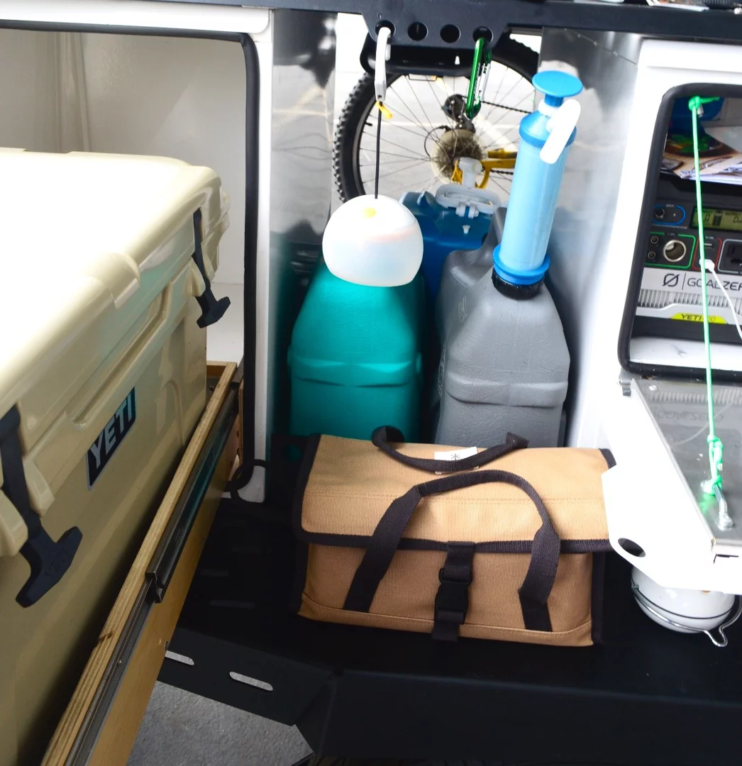 The open cubby in the middle is designed to hold things like jerry cans, propane and batteries