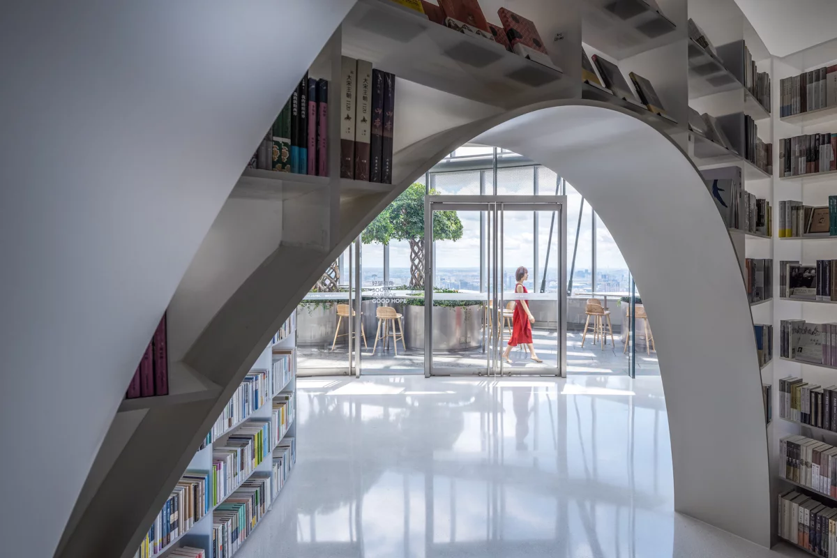 Books over the clouds' interior design is inspired by nature and the white bookshelves are envisioned as mountains