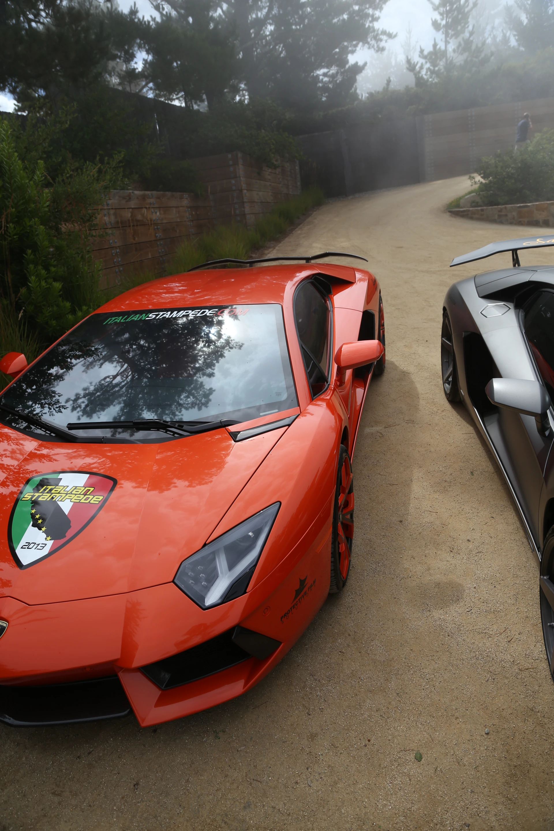 Burnt orange and matte grey Aventadors greet guests at the driveway (Photo: Angus MacKenzie/Gizmag.com)