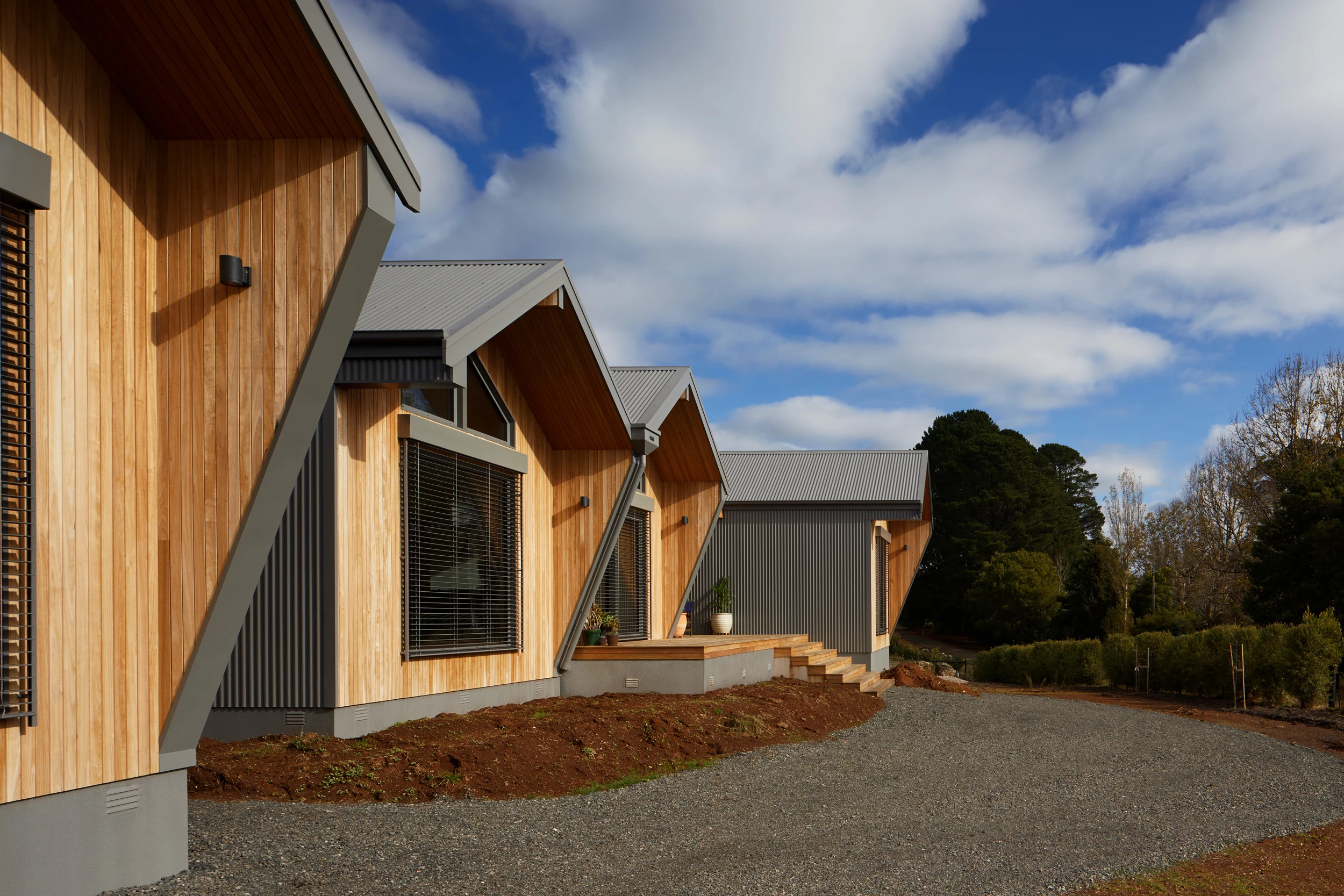 Owl Woods Passive House's structure resembles a cluster of birdhouses and draws inspiration from its natural bushland surroundings
