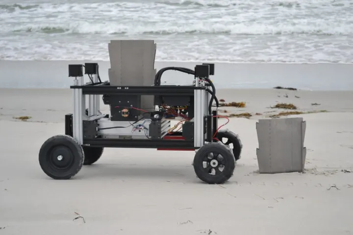 The Romu robot, seen here inserting sheet piles in the sand