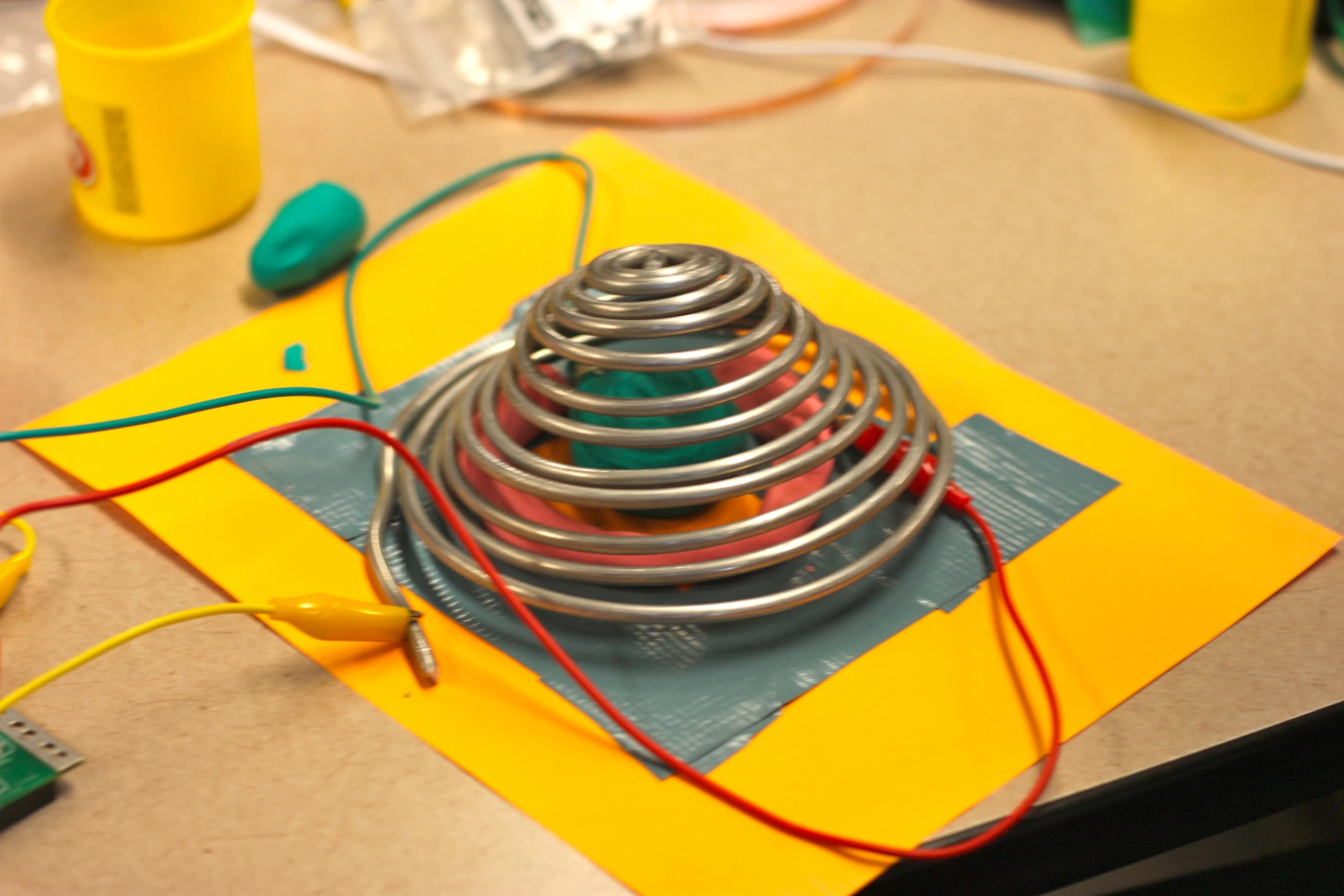 A grad student made this working pressure sensitive switch by layering Play-Doh under a spring
