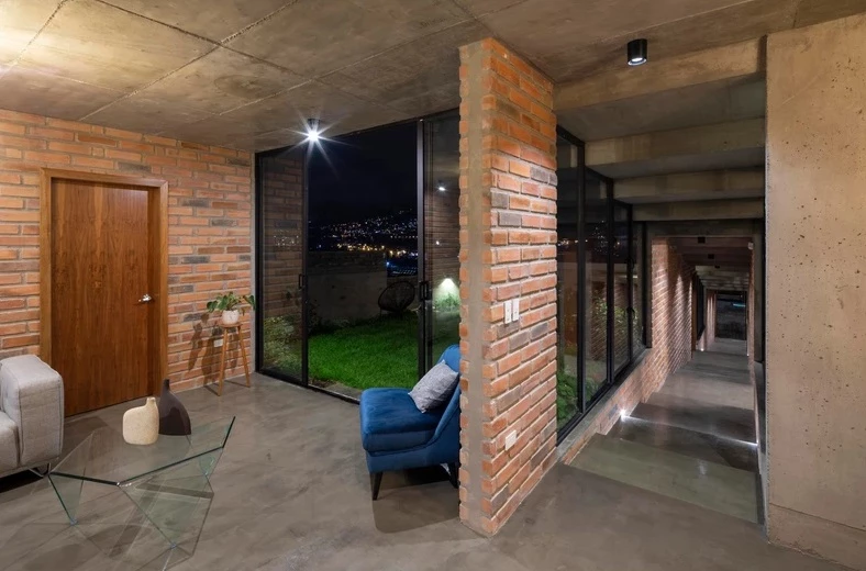 The interior features concrete flooring and ceilings and exposed brick walls