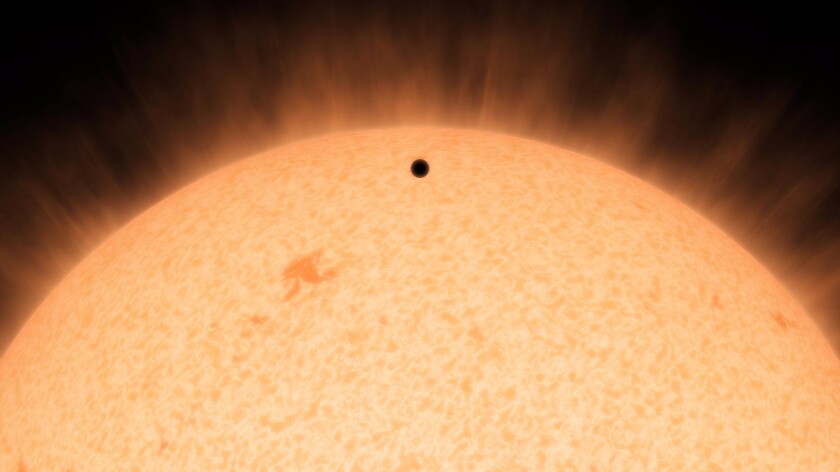 Artist's concept shows the silhouette of HD 219134b as it passes in front of its star