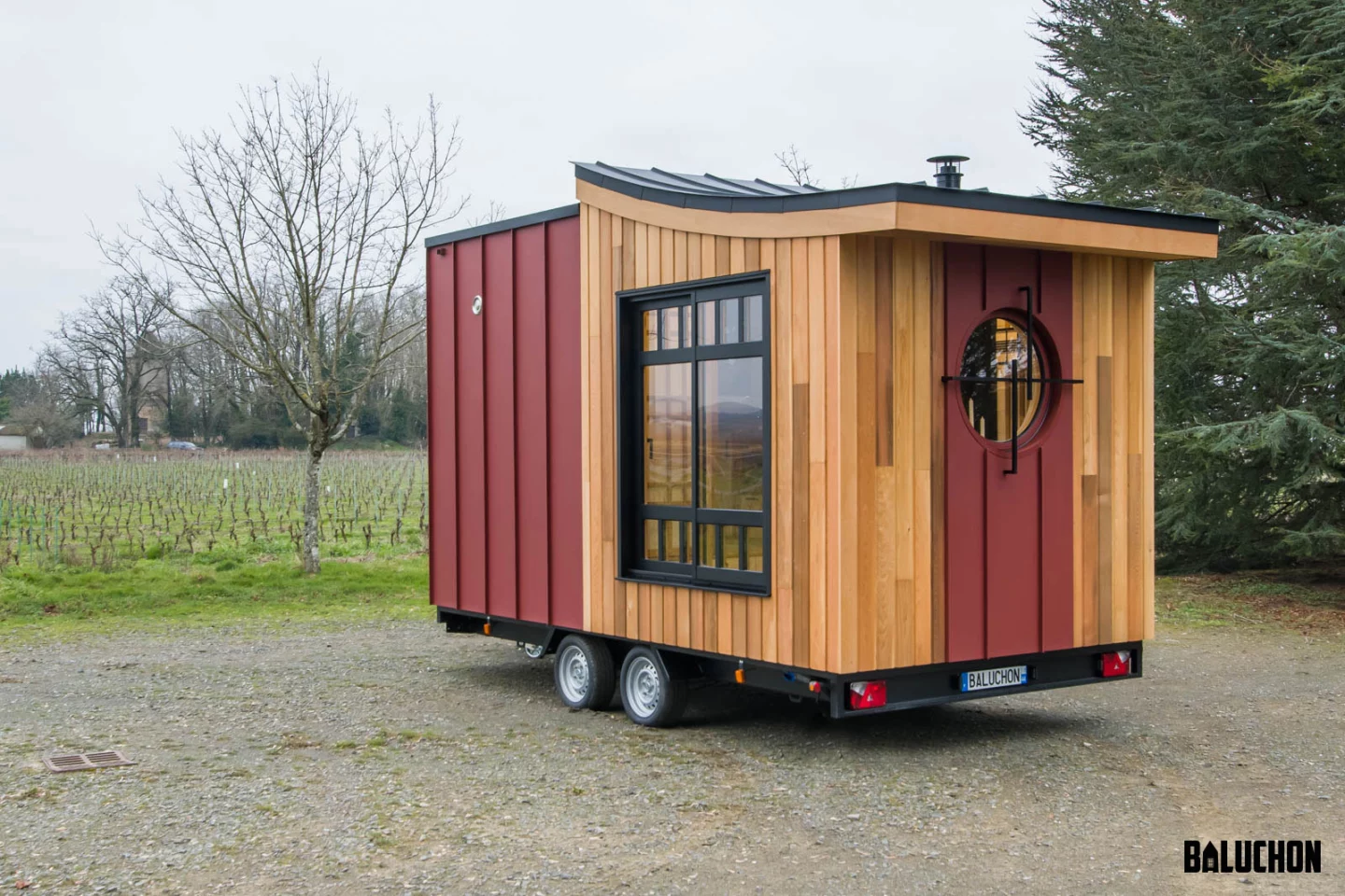 The Bonzai tiny house is based on a double-axle trailer and finished in red cedar, with a sloping aluminum roof