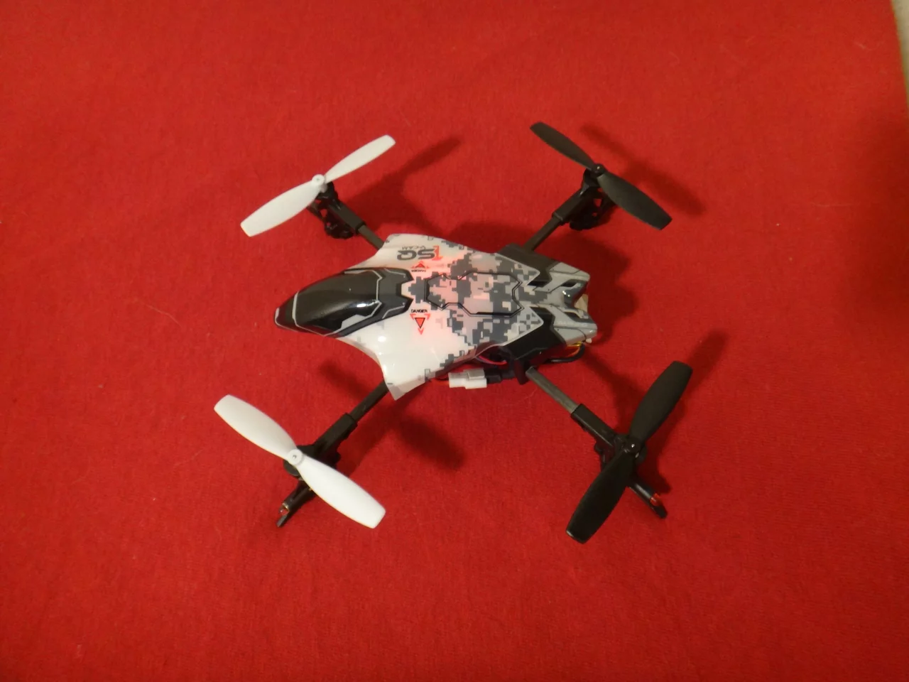 After connecting the battery cable and turning on the radio controls, a red light on the quadcopter indicated it was ready to go