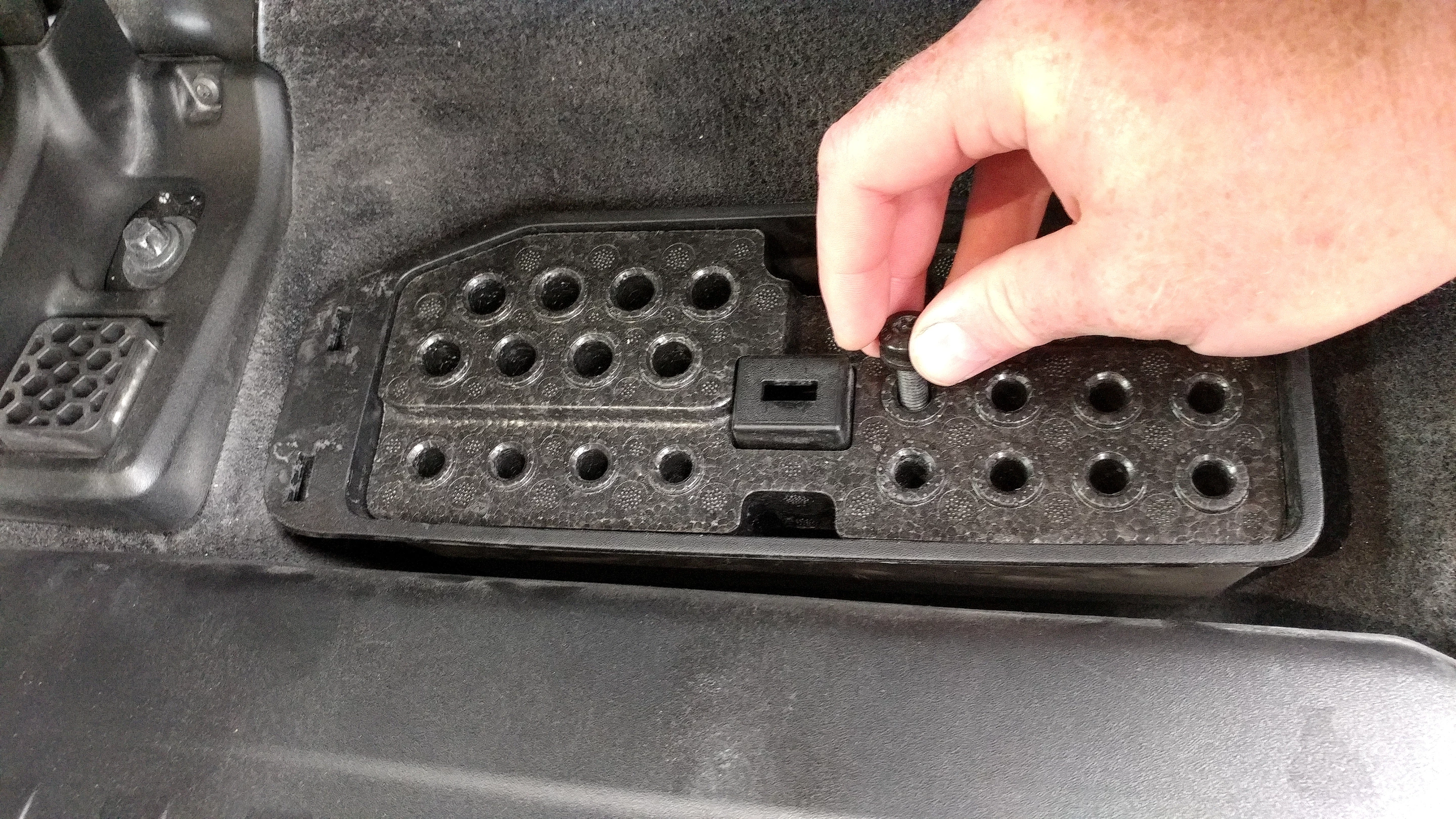 Thoughtful touches like this storage bin for the bolts removed when taking off roof, doors, or windshield are great Jeep items found in the Gladiator