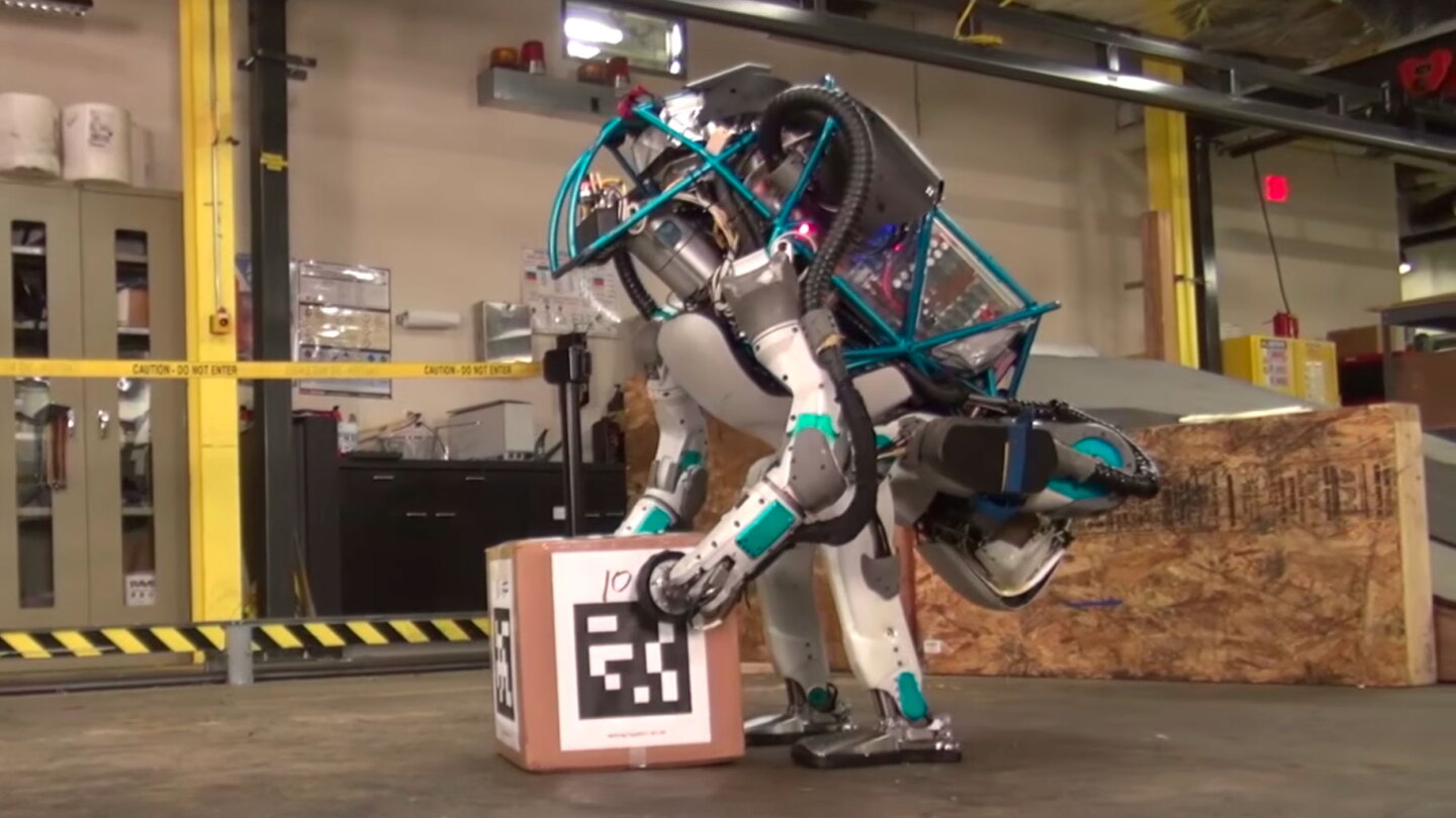 Boston Dynamics Latest Atlas Robot Struts Its Stuff Businesspeople lifting boxes off head. boston dynamics latest atlas robot