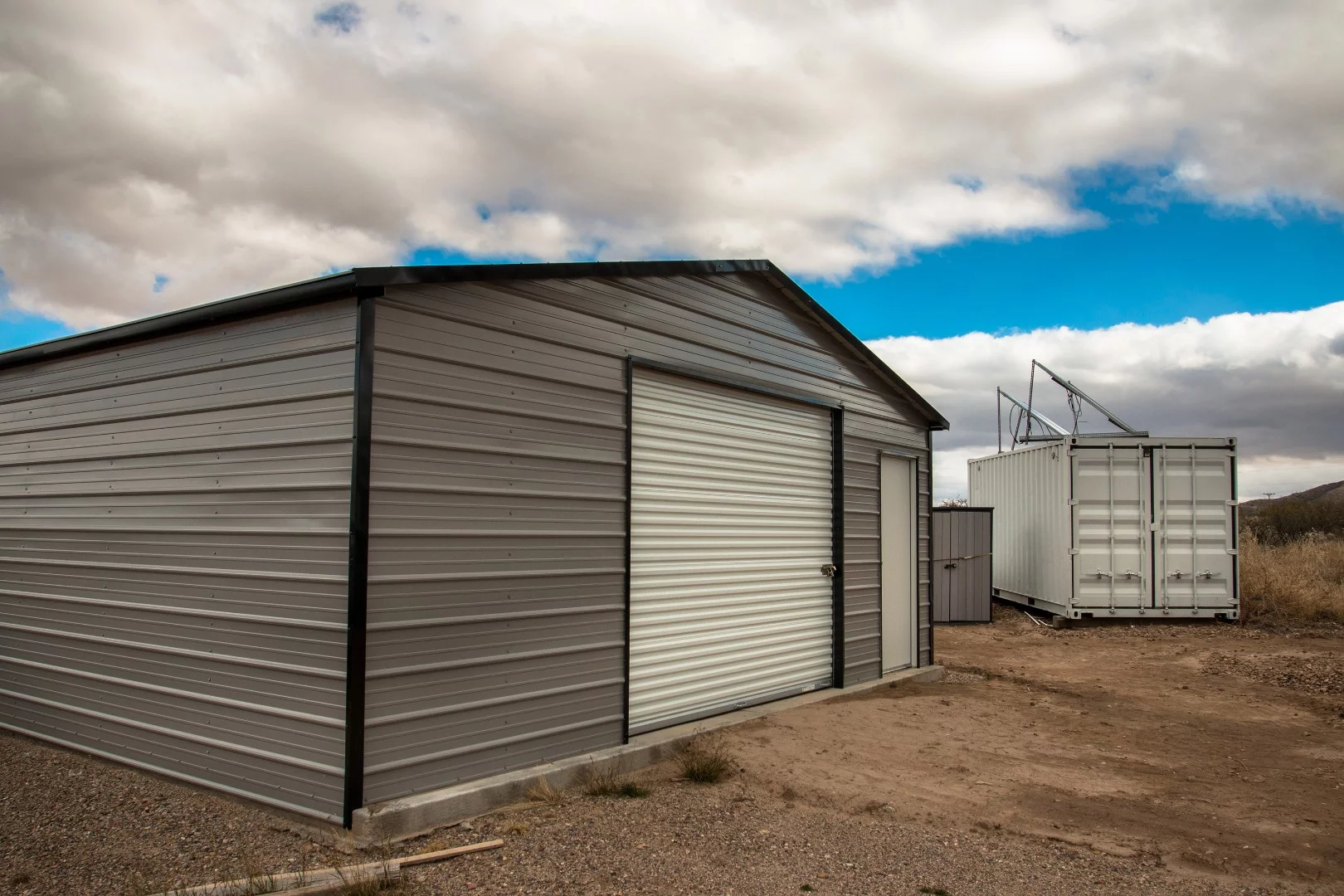The garage, the shipping container, and between is a small tool shed where his 12 volt water pump and propane tanks are.