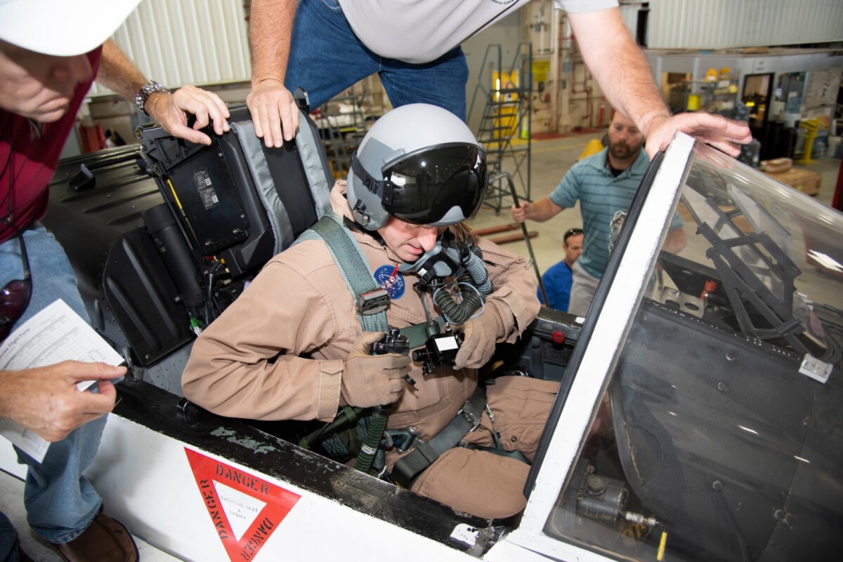 NASA pilot Jim Less sits in the cockpit of a NASA F/A-18 aircraft in preparation for flight tests that will be used to understand the physiological impacts that high-performance aircraft have on pilots