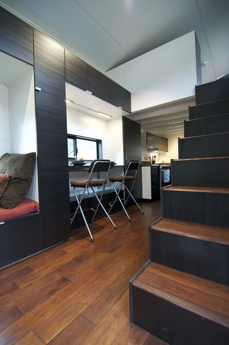 A staircase leads up to one of two raised loft areas