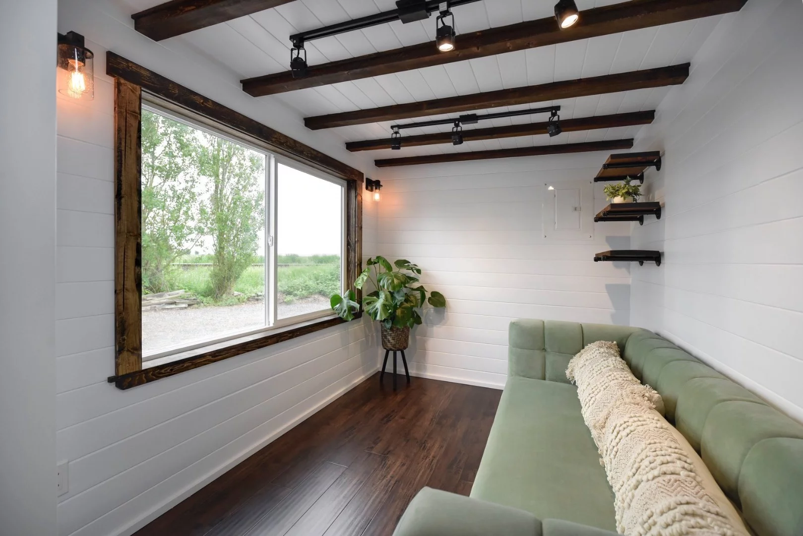 The Canada Goose's living room includes a sofa, and a large window ensures there's plenty of natural light inside