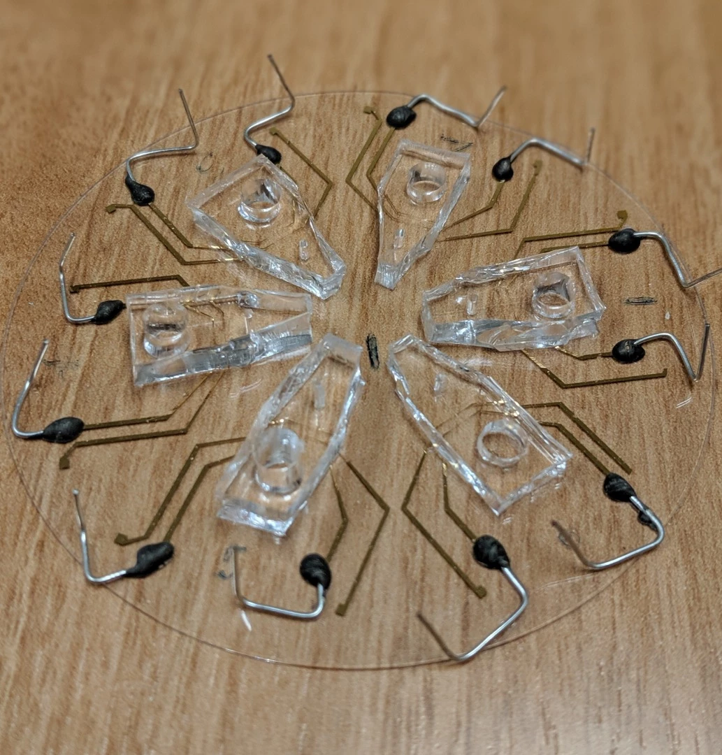 This image shows six devices (on a 3-inch-wide piece of glass) with biosensors to detect whether a cancer cell has responded to specific chemotherapy