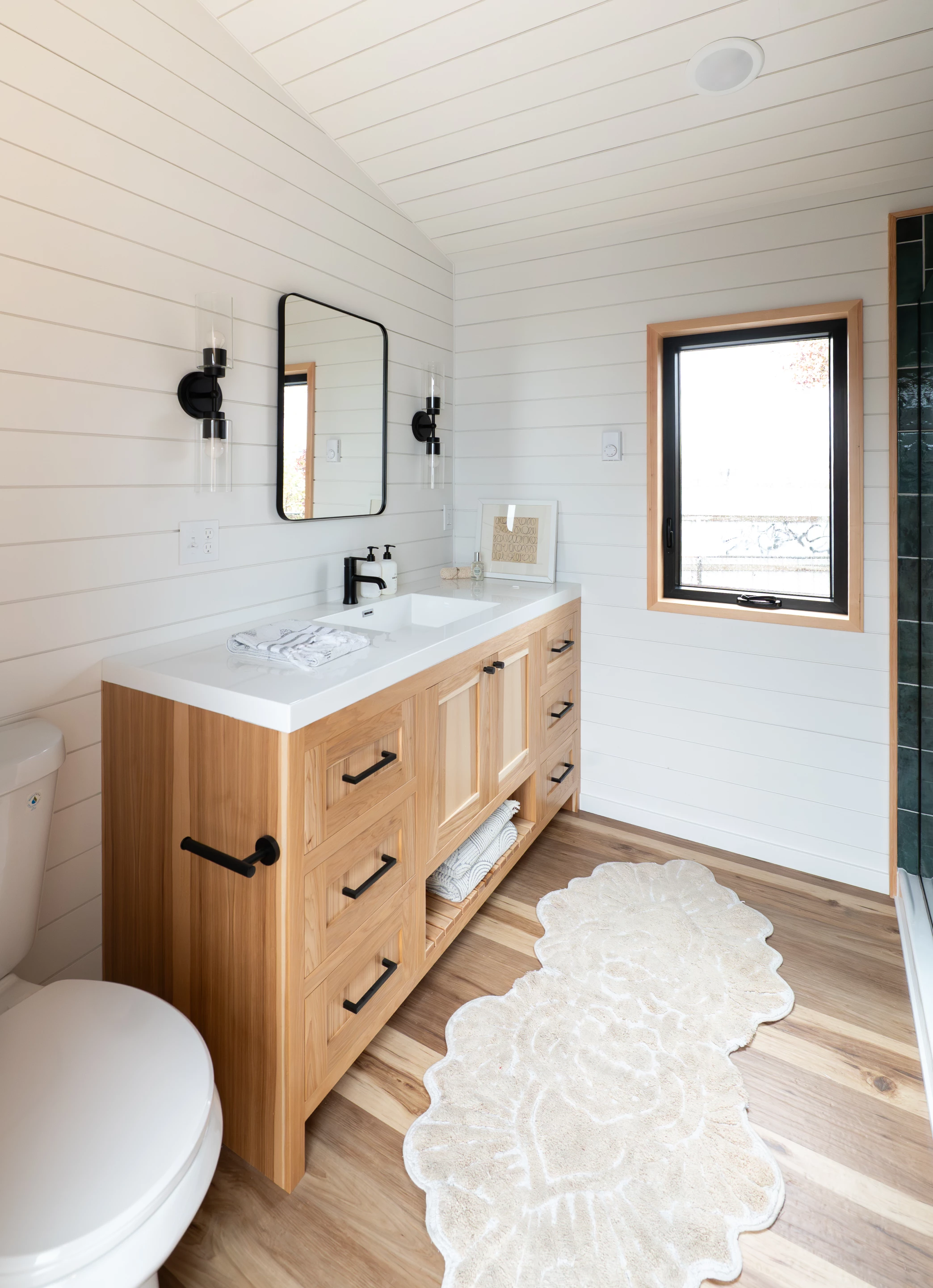 The Urban Park Max 37's bathroom includes a flushing toilet, a sink, a vanity sink, and a walk-in shower