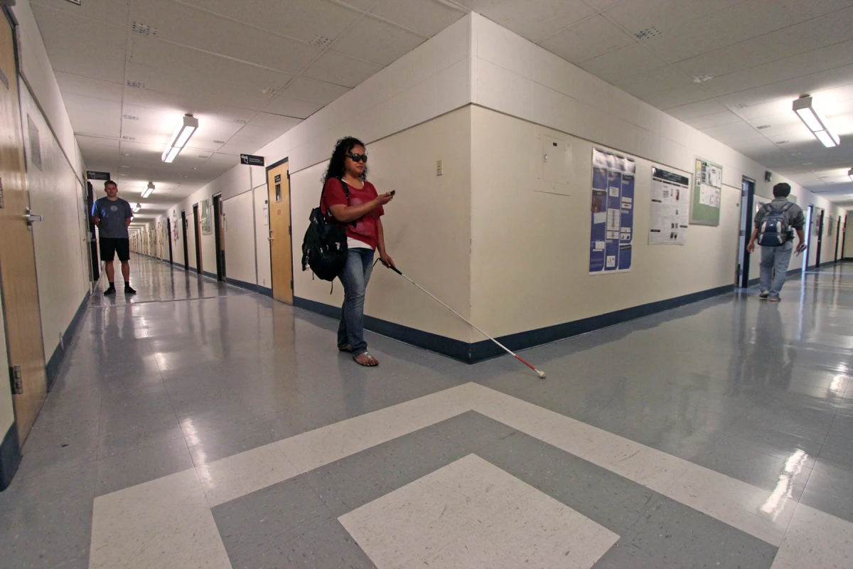 Eelke Folmer watches as student Dora Uchel demonstrates the Navatar system