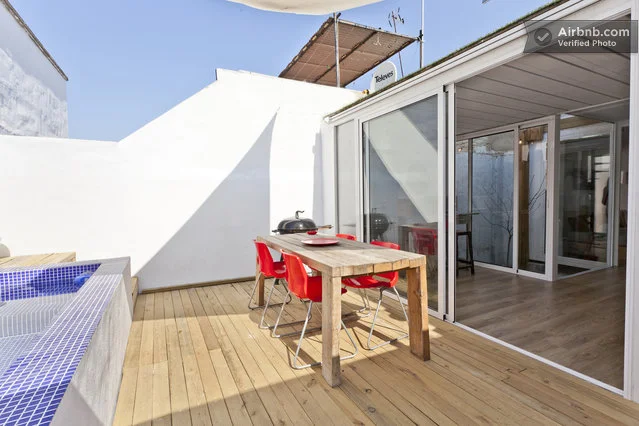 The fully equipped kitchen adjoins the adjacent living and dining areas, which open out to the outdoor courtyard