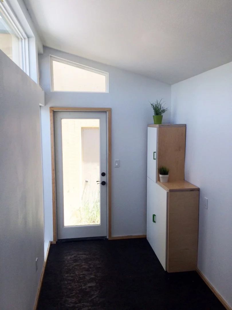 The interior of the shelter is open-plan and finished in white-painted drywall