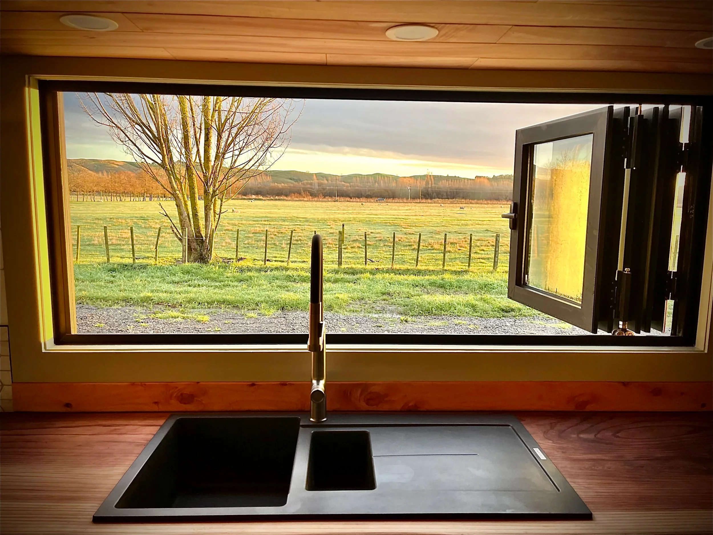 The Redwood's kitchen includes a bifold serving window that helps open it to the outside