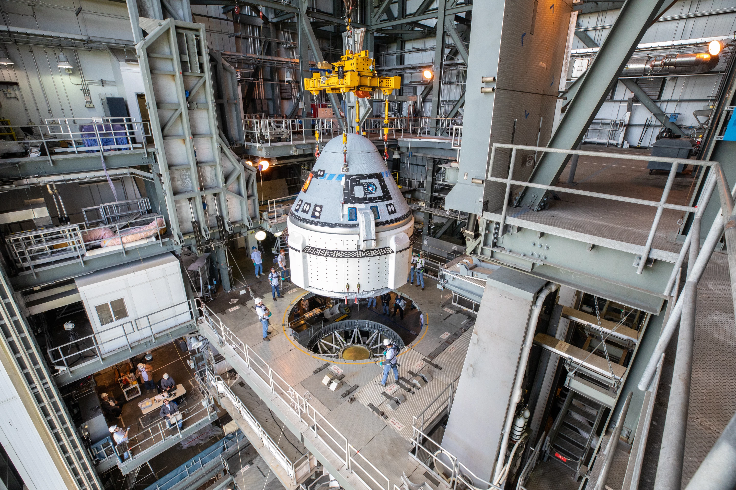 The Boeing CST-100 Starliner spacecraft is guided into position above a United Launch Alliance Atlas V rocket at the Vertical Integration Facility at Space Launch Complex 41 at Florida’s Cape Canaveral Air Force Station
