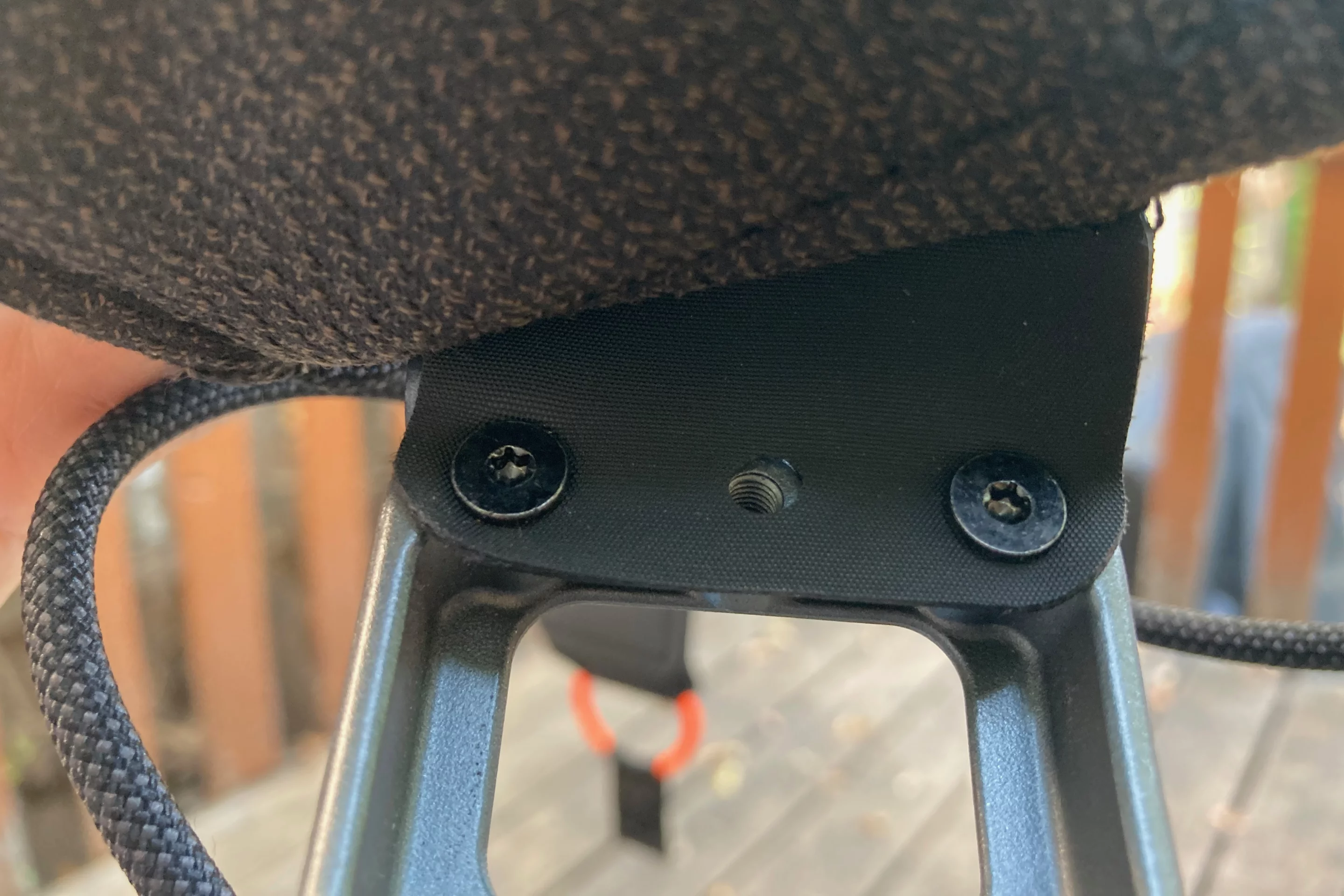 Two of the 12 screws that must be taken out in order to remove the padding for washing