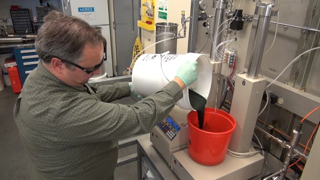 PNNL lab manager Tom Hart, pouring some of the unprocessed algae
