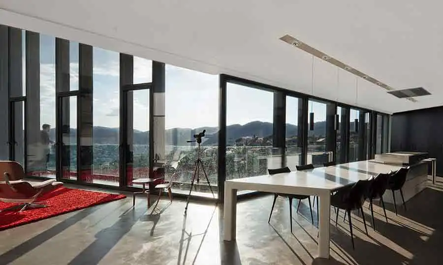 The views from the kitchen-diner of X House, with the huge marble dining table acting as a centerpiece