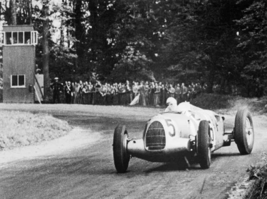 Rosemeyer hangs the back of his Auto Union 16-cylinder Type C out while exiting a turn at Donington Park, Great Britain during the 1937 British Grand Prix