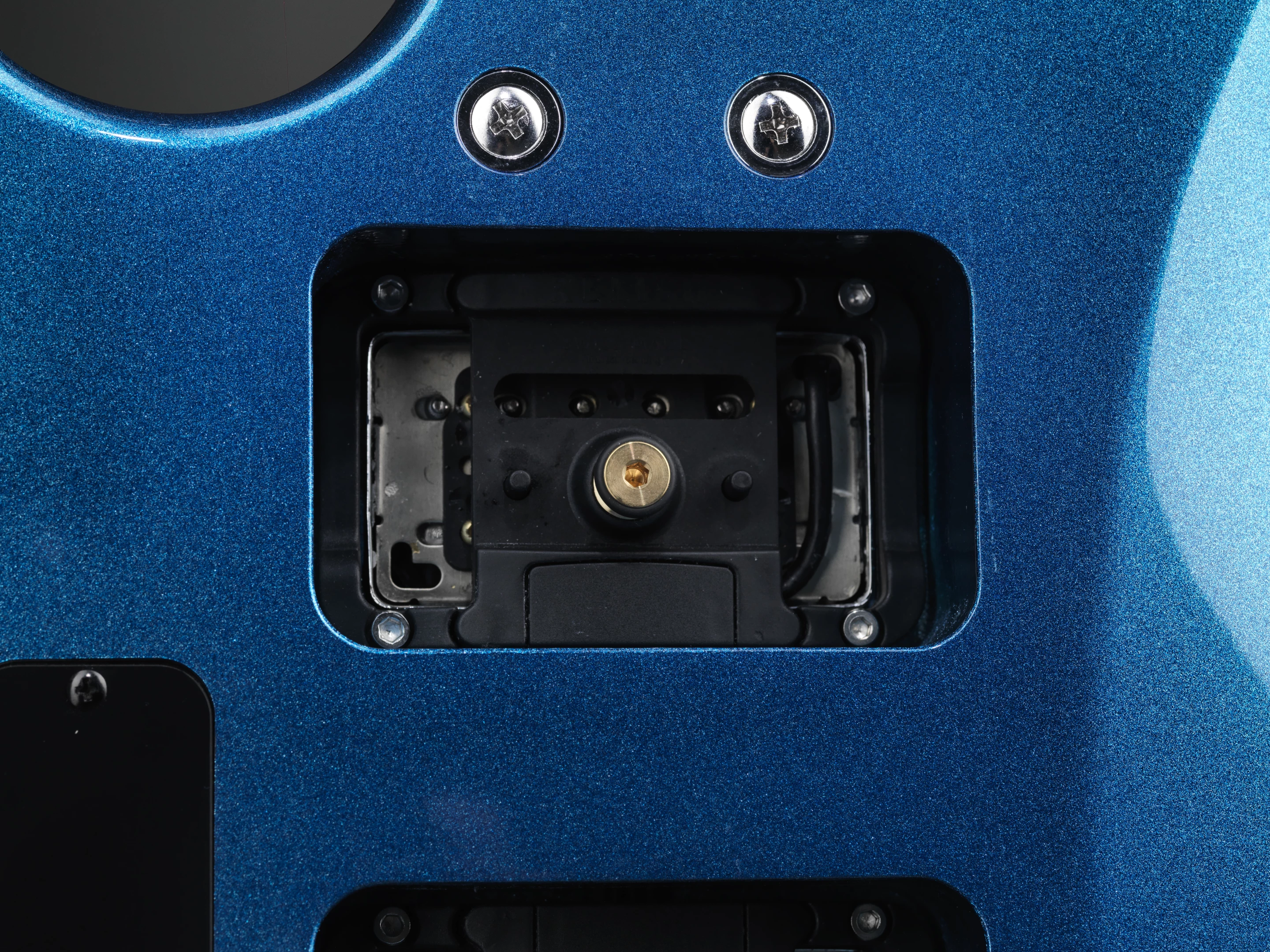 A humbucker-sized pickup is mounted to a special frame, which is then mounted inside the recess at the back